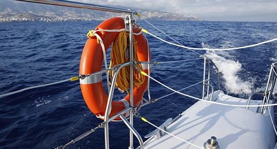 Life preserver mounted on the deck of a boat at sea