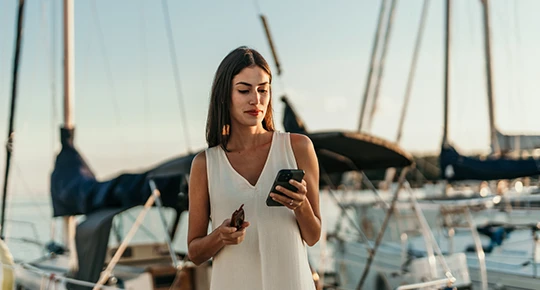 Woman on a boat looking at her phone